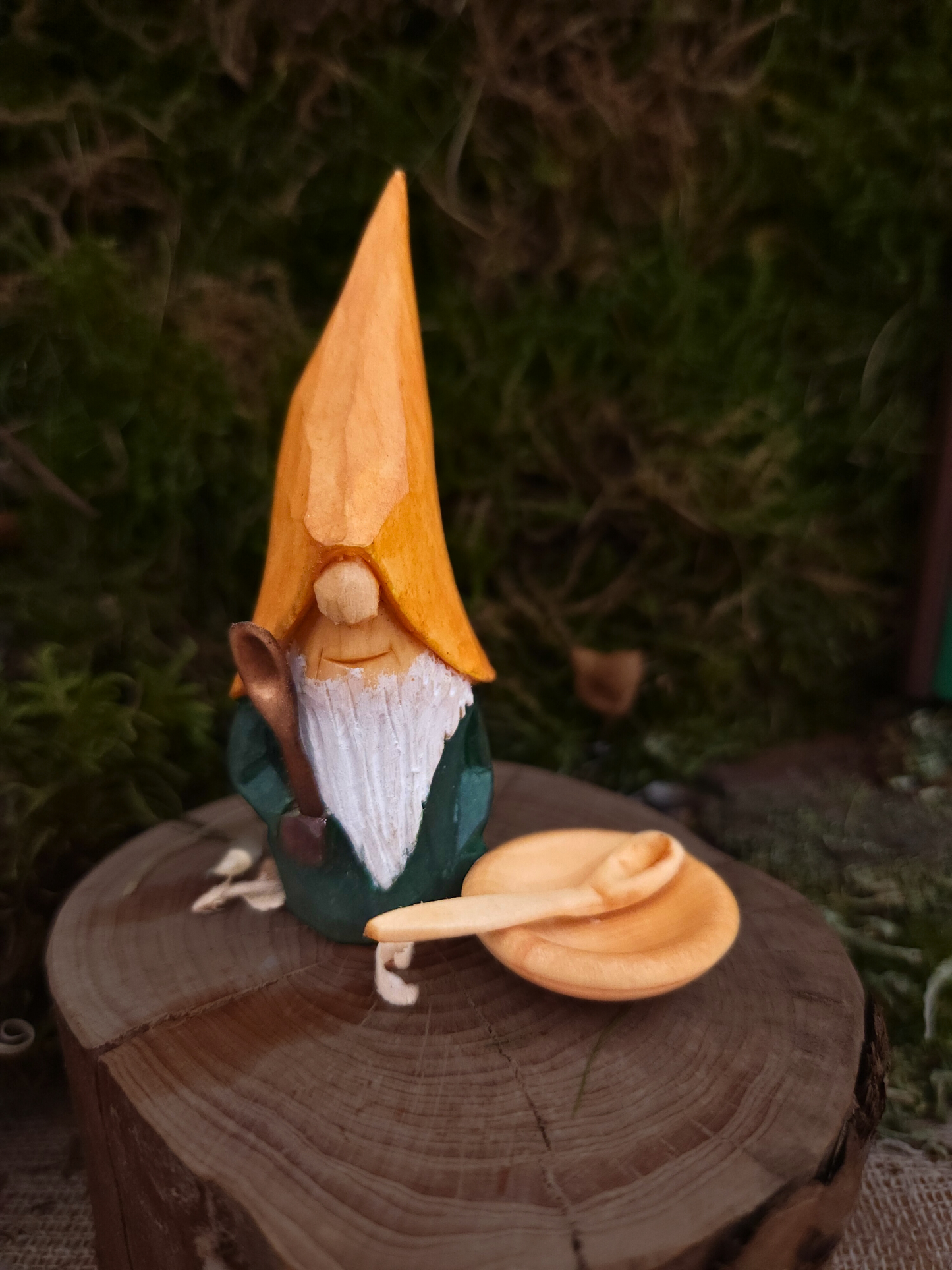 Hand-carved Nisse No. 71 with yellow hat and green body holding a wooden spoon.