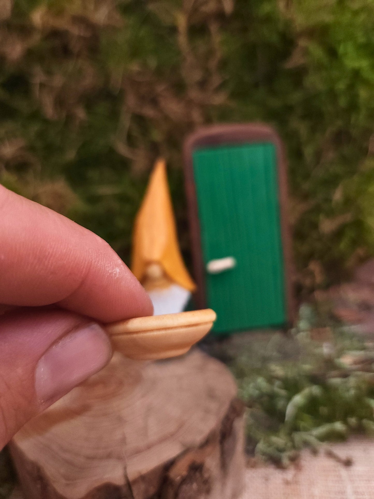 Hand-carved Nisse No. 71 with yellow hat, green body and wooden spoon – perfect for a miniature world or as a gift.