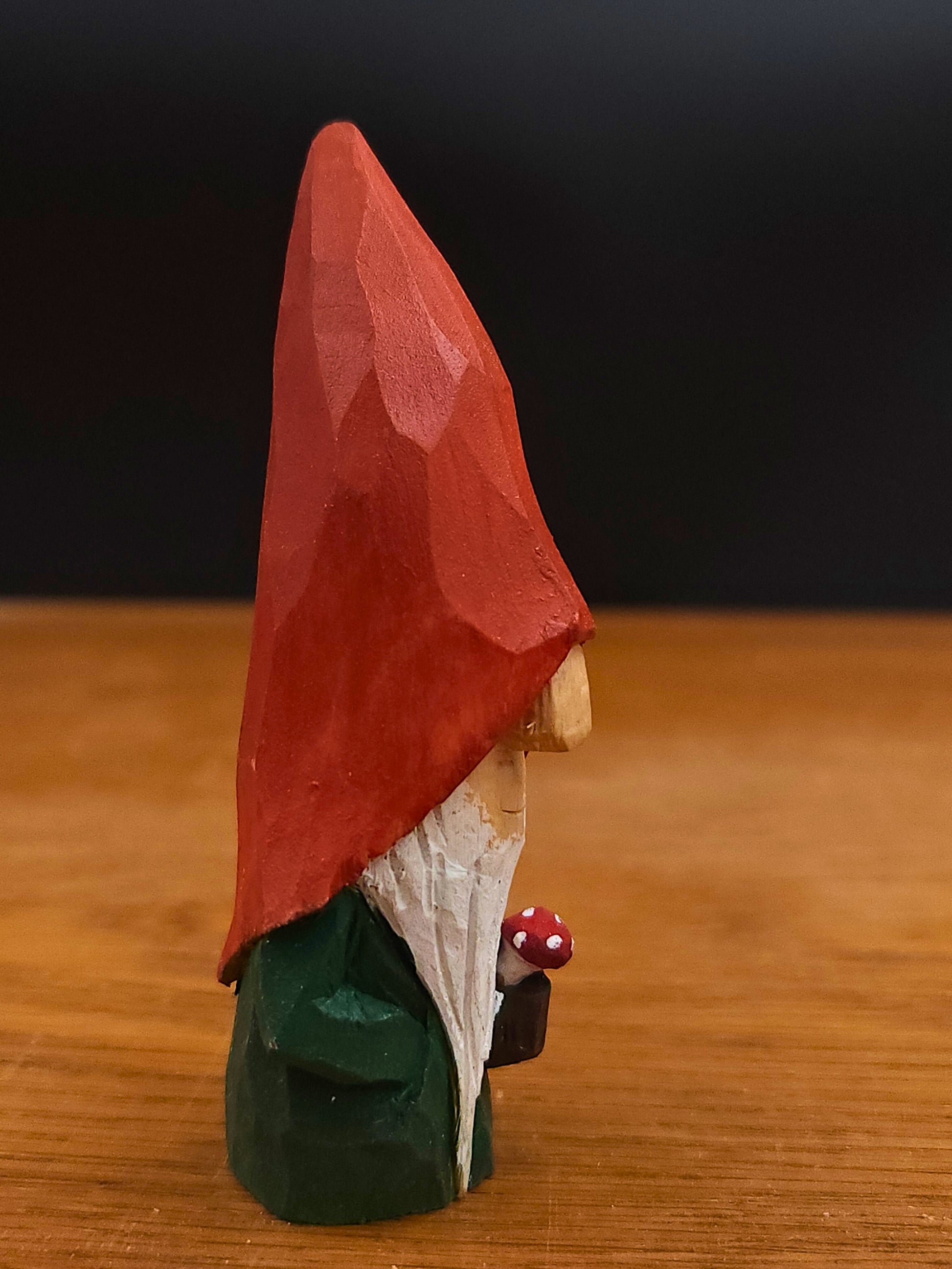 Gift idea – Autumn Nisse (Gnome, Wichtel) with red hat holding mushroom, hand-carved Scandinavian wooden folk art figure, unique signed collectible and Nordic seasonal decor.
