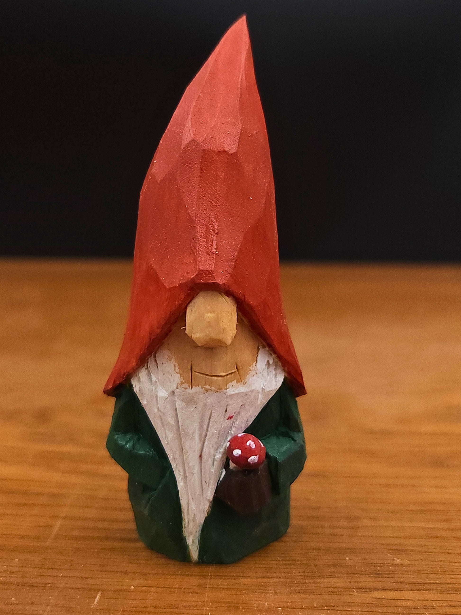 Gift idea – Autumn Nisse (Gnome, Wichtel) with red hat holding mushroom, hand-carved Scandinavian wooden folk art figure, unique signed collectible and Nordic seasonal decor.
